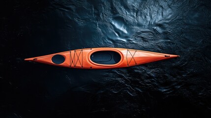 Fototapeta premium Top-down shot of a bright kayak in the middle of a dark, deep sea, with subtle reflections on the water's surface.