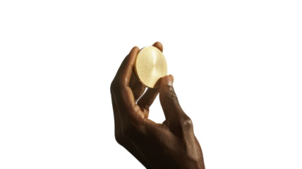 Holding an elegant crystal sphere against a vibrant yellow backdrop during creative exploration