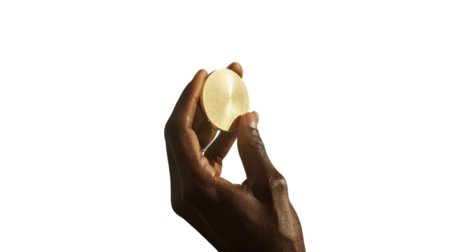 Holding an elegant crystal sphere against a vibrant yellow backdrop during creative exploration