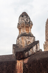 Wat Phra Si Rattana Mahathat Chaliang Khmer Ruin with a walking Buddha in classical Sukhothai style and apsara on front mini-prang