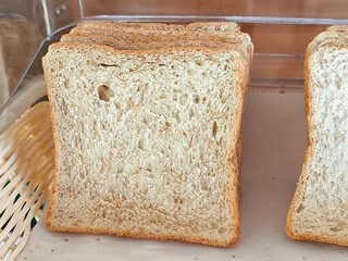 Sliced whole grain bread in tray. Fresh toast for breakfast