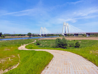 modern suspension bridge over a scenic river landscape