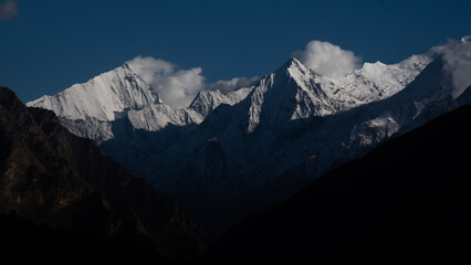 morning sun light illuminates snowclad himalayan peaks