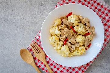 Homemade Stir Fried Cauliflower with Pork in white plate