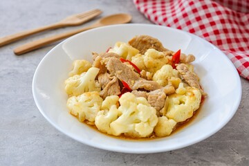 Homemade Stir Fried Cauliflower with Pork in white plate