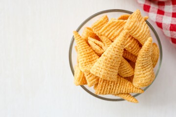 Clear cup of corn snack ,crispy corn snack on white background