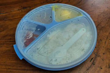 Rice side dishes in a blue Tupperware lunch box on the table