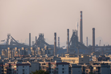 An industrial cityscape in Liuzhou, China, featuring rows of residential buildings and a sprawling...
