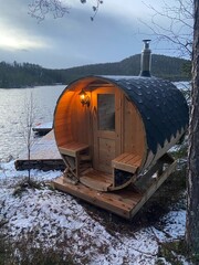 sauna at dusk on calm lake in scandinavia