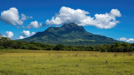 Scenic mountain landscape with vibrant clouds and lush greenery in a tranquil nature reserve setting.