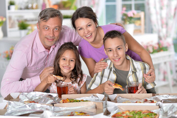 Portrait of beautiful family cooking at kitchen