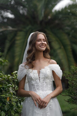 A Beautiful Bride Dressed in an Elegant Wedding Dress Surrounded by Lush Greenery and Nature