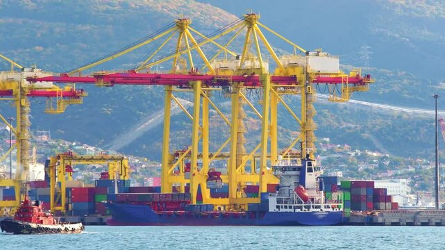 Working crane bridge lifting container cargo to freight ship at shipyard in morning. Transportation and Logistics in the city. 
