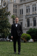 A Classy and Elegant Man Dressed in Formal Attire Posing Gracefully Outdoors in Nature