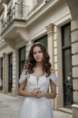 An Elegant Bride Wearing a Stunning Wedding Dress Strolling on a Charming City Street