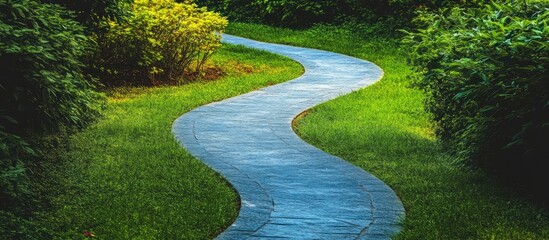 Serene curved pathway meandering through a lush green garden surrounded by vibrant foliage and tranquil nature.