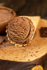 chocolate ice cream in a cone on a board