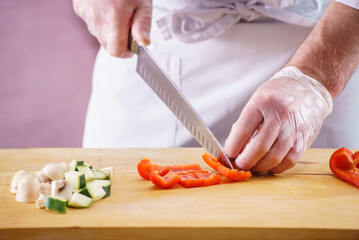 .Chef cutting fresh and delicious vegetables for cooking