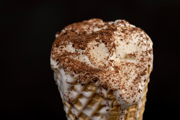 sweet melting white ice cream with chocolate chips in a waffle cone