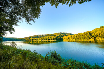 View of the Hennesee in Sauerland and the surrounding green landscape. Nature by the lake with a...