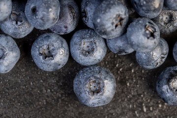 a pile of blueberries scattered on the board