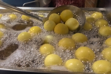 Buñuelos from Colombia in the process of cooking, traditional Colombian food.