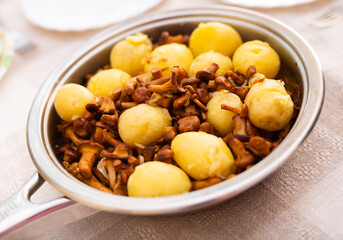 Delicious fried chanterelles with new potatoes in a frying pan