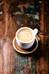 Cup of coffee on wooden background. Close up