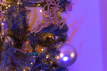 A detailed closeup view of a beautifully decorated Christmas tree adorned with stunning purple...