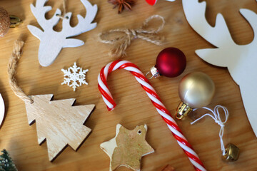 Various Christmas decorations in neutral colors on wooden background. Selective focus.