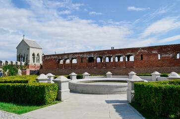 Historic Rabat Castle with Golden Dome, White Arches, and Lush Gardens Featuring Fountains Pools and beautiful colorful flowers surrounding old wall