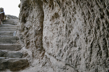 Entrance steps with small lighting into a stone cave