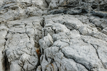 Texture of gray rock up close, rocks on islands in Greece, undulating rocks