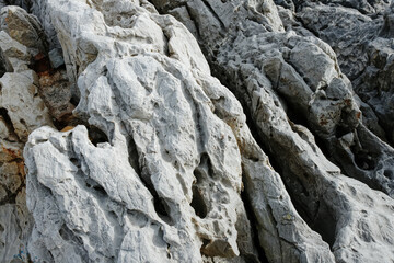Texture of gray rock up close, rocks on islands in Greece, undulating rocks
