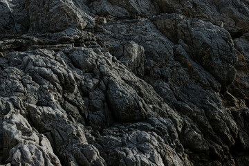 Texture of gray rock up close, rocks on islands in Greece, undulating rocks