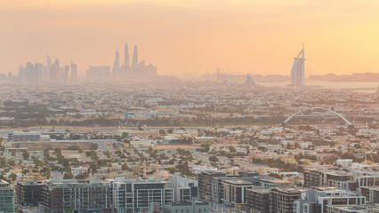 Dubai skyline with Dubai Marina skyscrapers and coastline at sunset timelapse with seven star luxury hotel in Dubai, UAE.