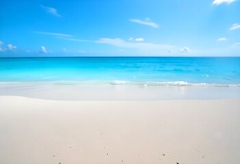 Fototapeta premium A tropical beach with white sand and clear turquoise water under a blue sky with wispy clouds
