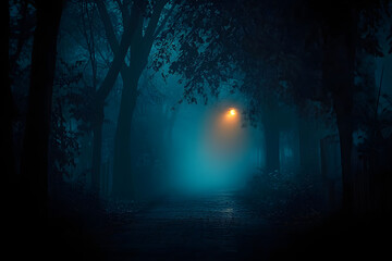 Mysterious pathway through the dark foggy forest in cold tones. Halloween background.