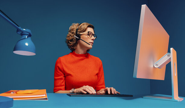 Female clerk working on computer and typing