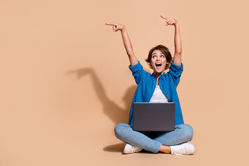 Full body size photo of young modern technologies engineer woman direct fingers settings with netbook isolated on beige color background