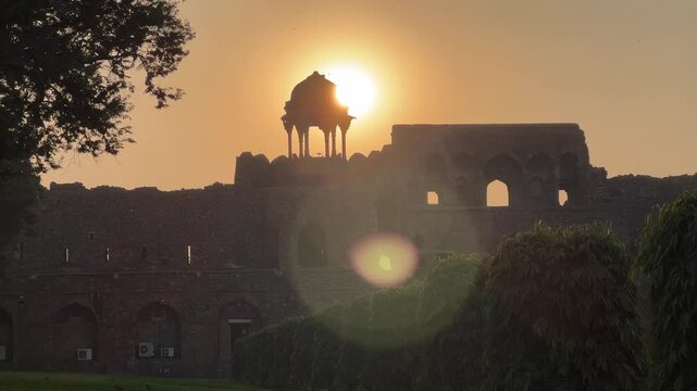 View of Purana Quila Fortress at sunset with foreground garden in New Delhi, India
