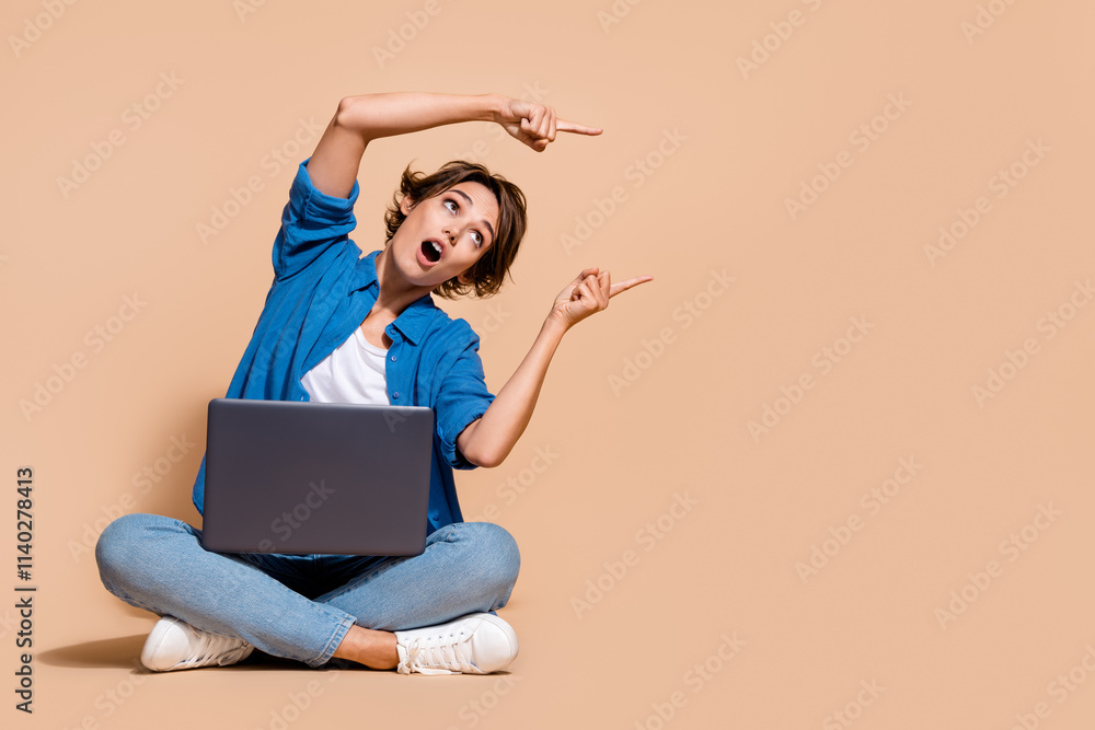 Poster Full size photo of system administrator woman point fingers website she created ux design using laptop isolated on beige color background