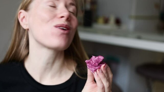 girl eat homemade zephyr. Homemade marshmallows. A woman puts a ready-made zephyr