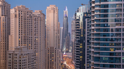 Obraz premium Evening illumination of Dubai Marina day to night aerial timelapse, UAE.