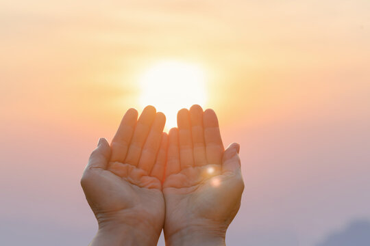 Closeup human hands placed together like praying worship at sunset.worship god with christian concept religion.