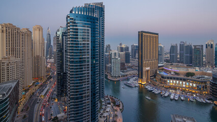Evening illumination of Dubai Marina day to night aerial timelapse, UAE.