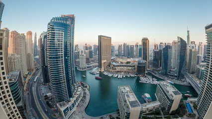 Naklejka premium Evening illumination of Dubai Marina day to night aerial timelapse, UAE.