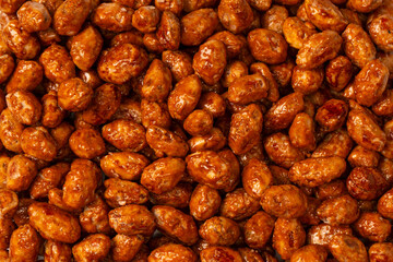 Tasty sweet roasted peanuts as a background.