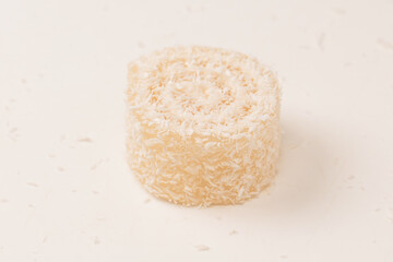 Coconut candy roll isolated on a white background.
