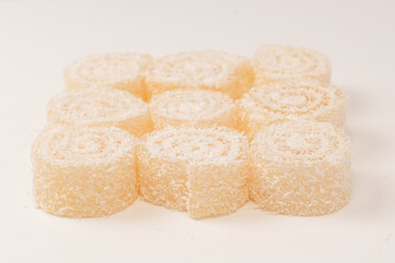 Coconut candy roll isolated on a white background.